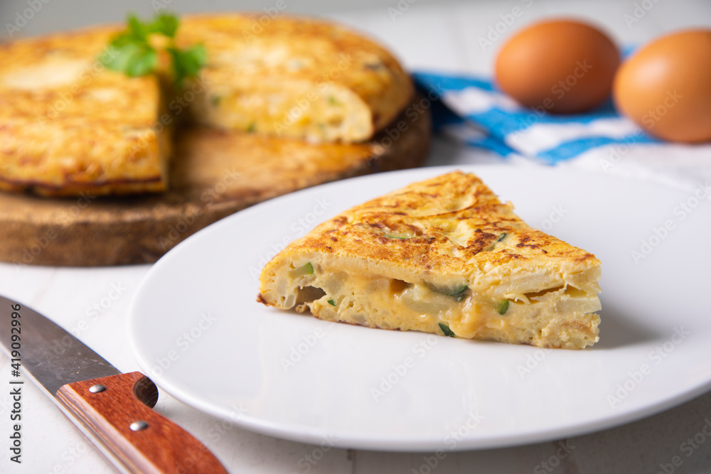 Traditional Spanish omelette with potatoes and zuuchini