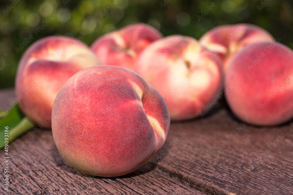 Fresh Peach fruits in blur background, Peach on wooden table in garden. Fresh Peach fruits in blur background, Peach on wooden table in garden.