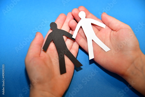 black and white figure in palms on a blue background