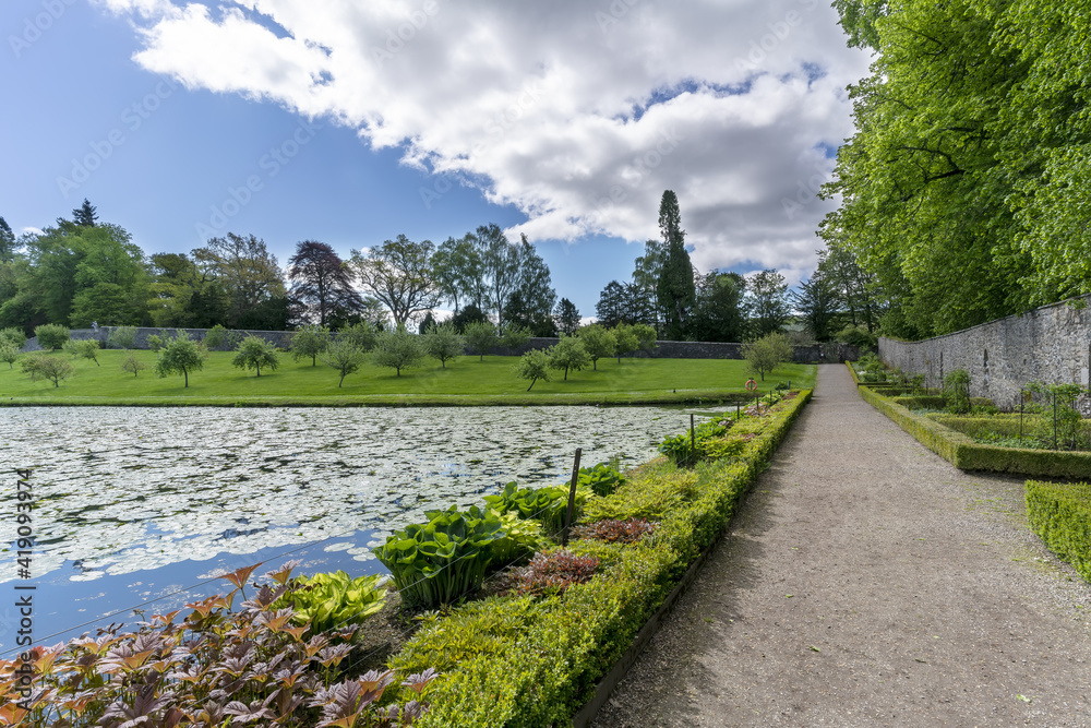 Garden and pond in White elegant Blair Castle locates near the village of Blair Atholl , one of the most tourist attractions in Scottish Highlands Garden and pond in White elegant Blair Castle locates near the village of Blair Atholl , one of the most tourist attractions in Scottish Highlands