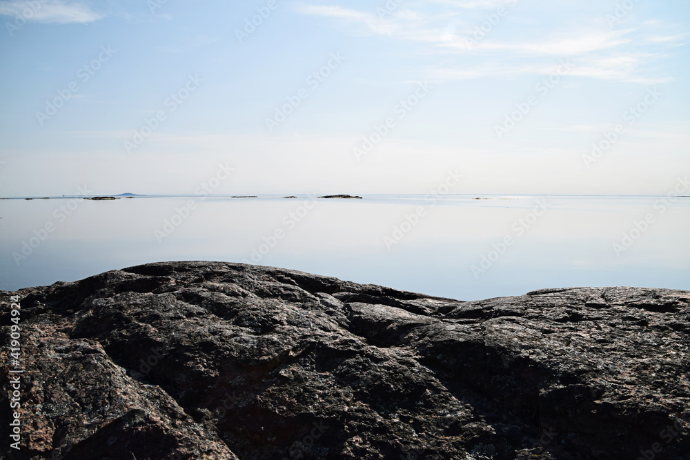 Calm water this sunny day in the archipelago. Focus on the foreground and the rock formation, typical for the Swedish archipelago nature. Photo taken outside Oskarshamn, Sweden