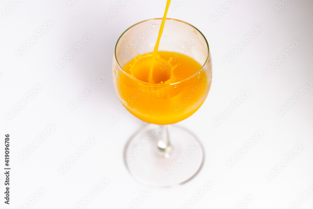 Orange juice is being poured into the glass. Drink Orange juice is being poured into the glass. Drink