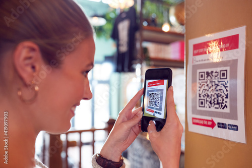 Valokuva Woman With Mobile Phone Checking Into Venue Scanning QR Code During Health Pande