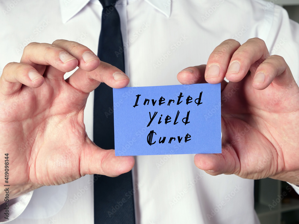 Financial concept about Inverted Yield Curve with sign on the page. Financial concept about Inverted Yield Curve with sign on the page.