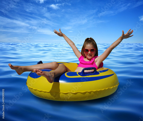 Little girl on inflatable ring in blue sea water © Alekss