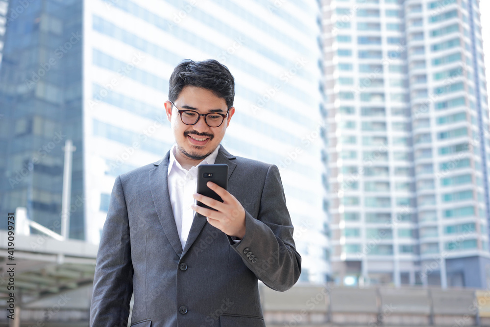 close up adult mixed race of middles eastern businessman holding smartphone and standing outside company over city building background for future vision concept close up adult mixed race of middles eastern businessman holding smartphone and standing outside company over city building background for future vision concept