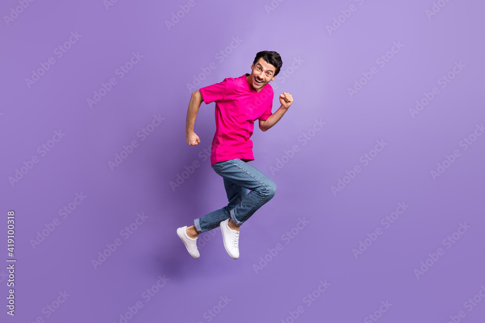 Full length profile portrait of excited person running toothy smile look camera isolated on purple color background