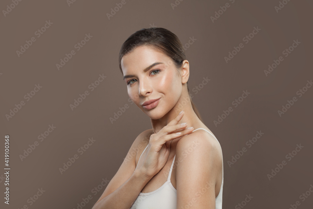 Obraz premium Healthy model woman with clear skin on brown background. Facial treatment, cosmetology and skin care concept