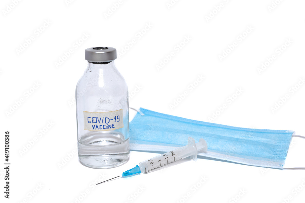 Coronavirus vaccine ampoule, disposable syringe and medical face mask isolated on white background Coronavirus vaccine ampoule, disposable syringe and medical face mask isolated on white background