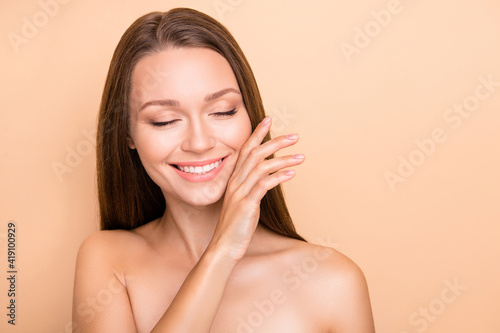 Photo of young girl dream dreamy hand touch cheek soft perfect skin isolated over beige color background