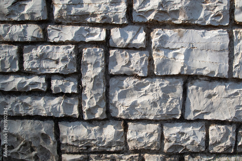 White stone wall, abstract background texture with old and vintage style pattern. garden wall design backdrop.