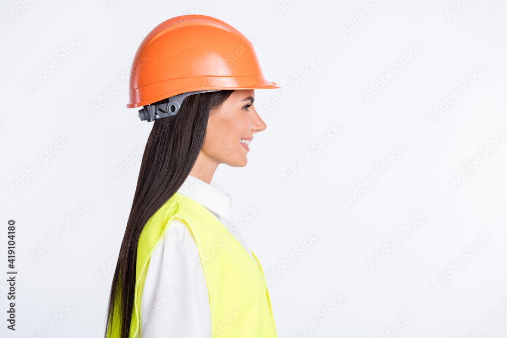 Profile photo of positive lady look empty space shiny smile wear helmet shirt vest isolated white color background Profile photo of positive lady look empty space shiny smile wear helmet shirt vest isolated white color background