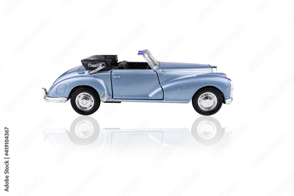 Blue toy convertible car side view, isolated on white background.