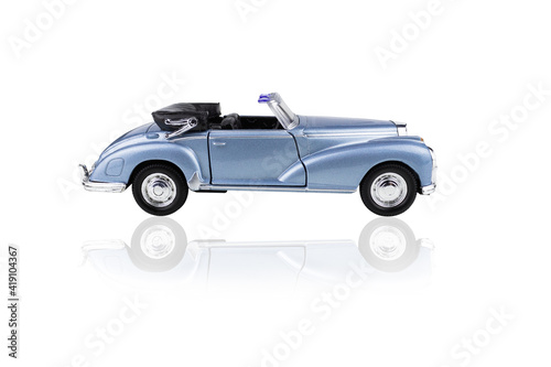 Blue toy convertible car side view, isolated on white background.