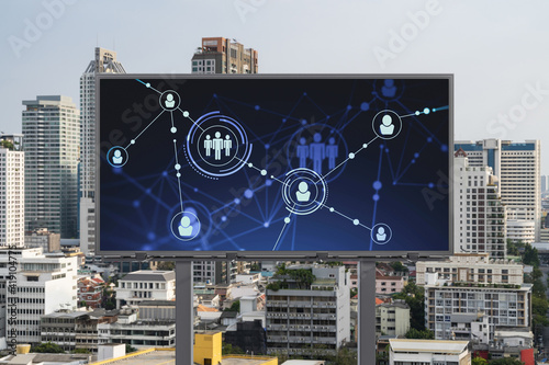 Glowing Social media icons on road billboard over panoramic city view of Bangkok, Southeast Asia. The concept of networking and establishing new connections between people and businesses.