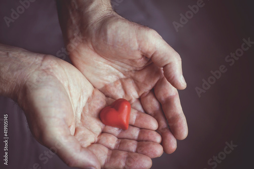 Little red heart in men's hands