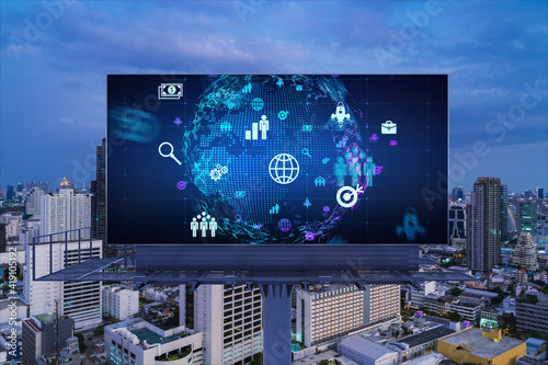 World planet Earth map hologram and social media icons on billboard over night panoramic city view of Bangkok, Southeast Asia. Networking and establishing new connections between people. Globe