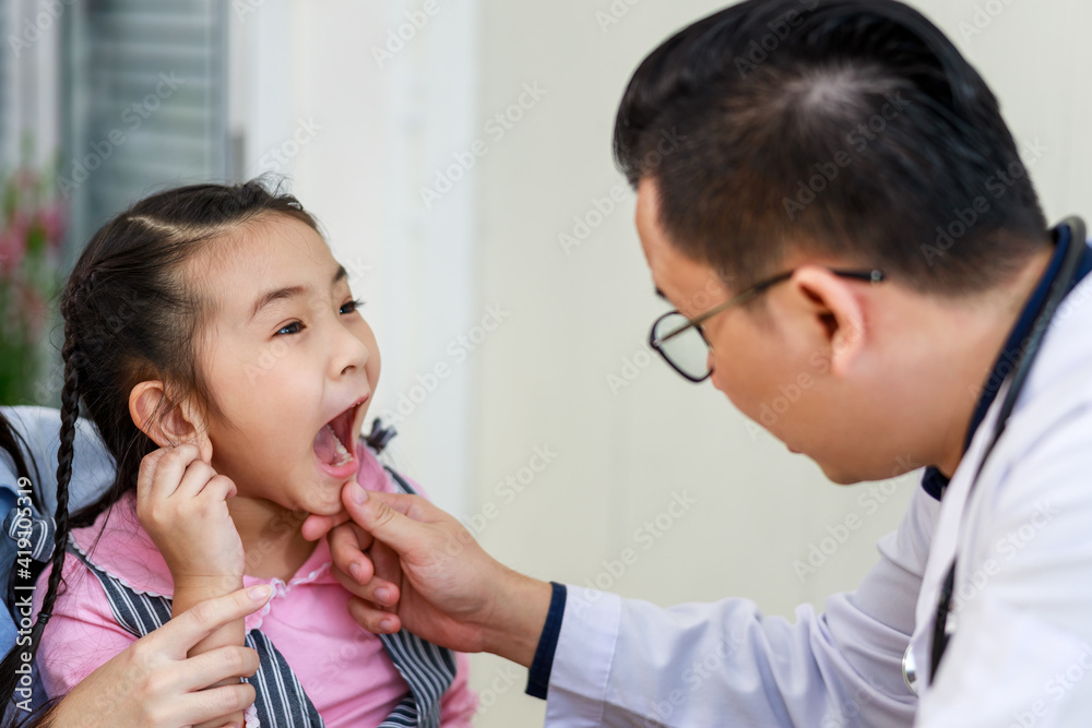 Dentist examining teeth of little girl at dental clinic Dentist examining teeth of little girl at dental clinic