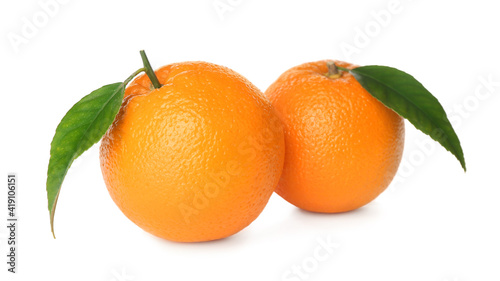 Fresh ripe oranges with green leaves on white background