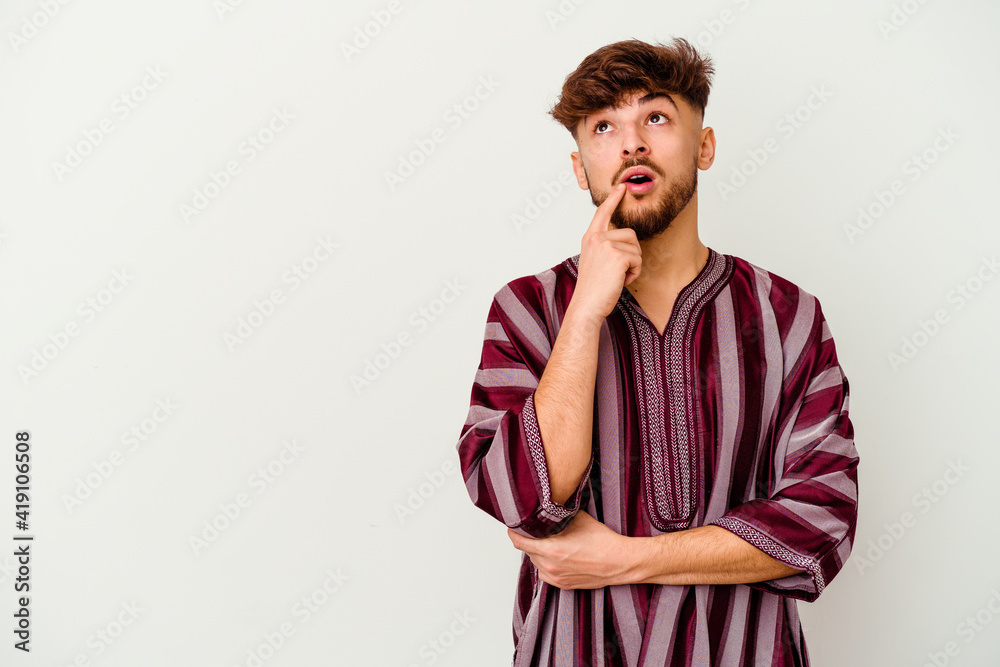 Young Moroccan man isolated on white background looking sideways with doubtful and skeptical expression. Young Moroccan man isolated on white background looking sideways with doubtful and skeptical expression.