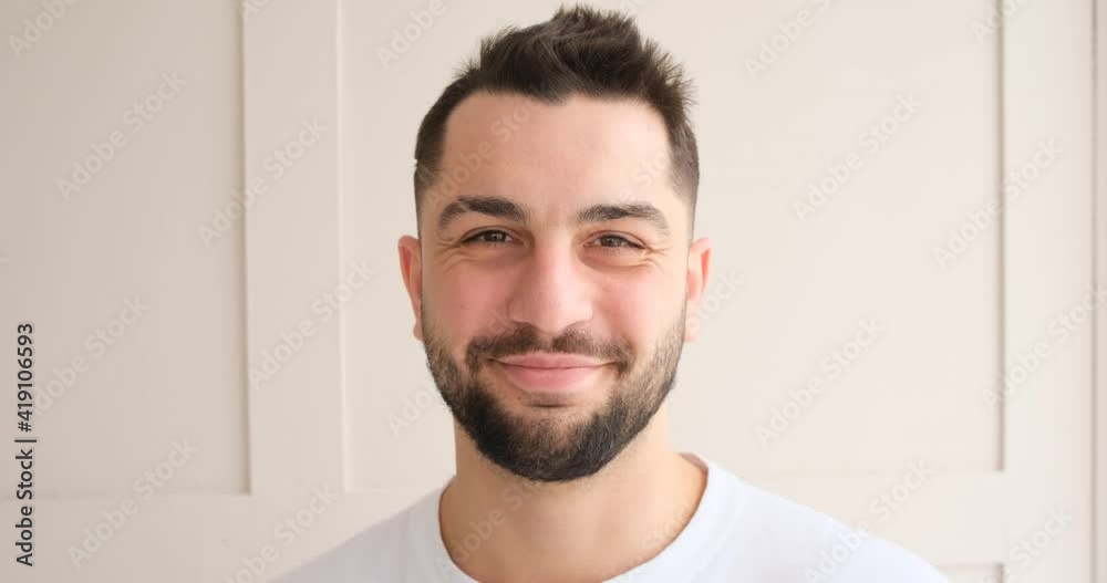 Smiling adult man look at camera on background