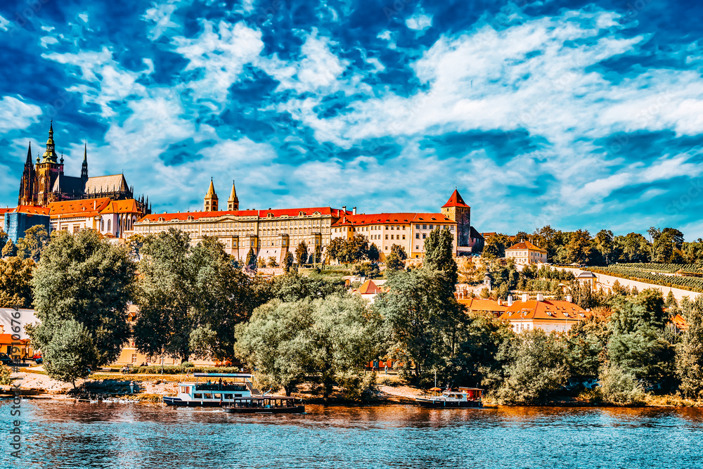 View of Prague Castle from waterfront- famous historic bridge that crosses the Vltava river in Prague, Czech Republic.
