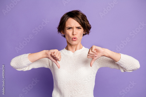 Photo of unsatisfied person show two thumbs down bad mood sullen isolate don violet color background photo