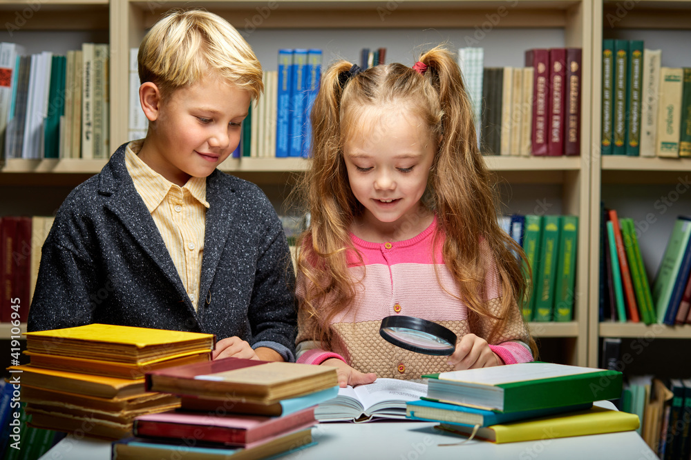 boy and girl reading book in school library, people lifestyles and friend Education and friendship concept. leisure time for children, group activity boy and girl reading book in school library, people lifestyles and friend Education and friendship concept. leisure time for children, group activity