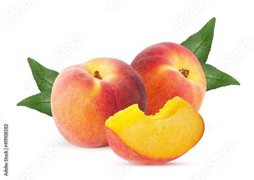 Two ripe peach fruit with slice and leaf
