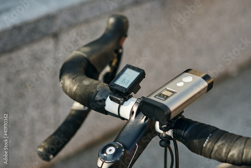 Close up shot of equipment and accessories attached to professional bike handlebar