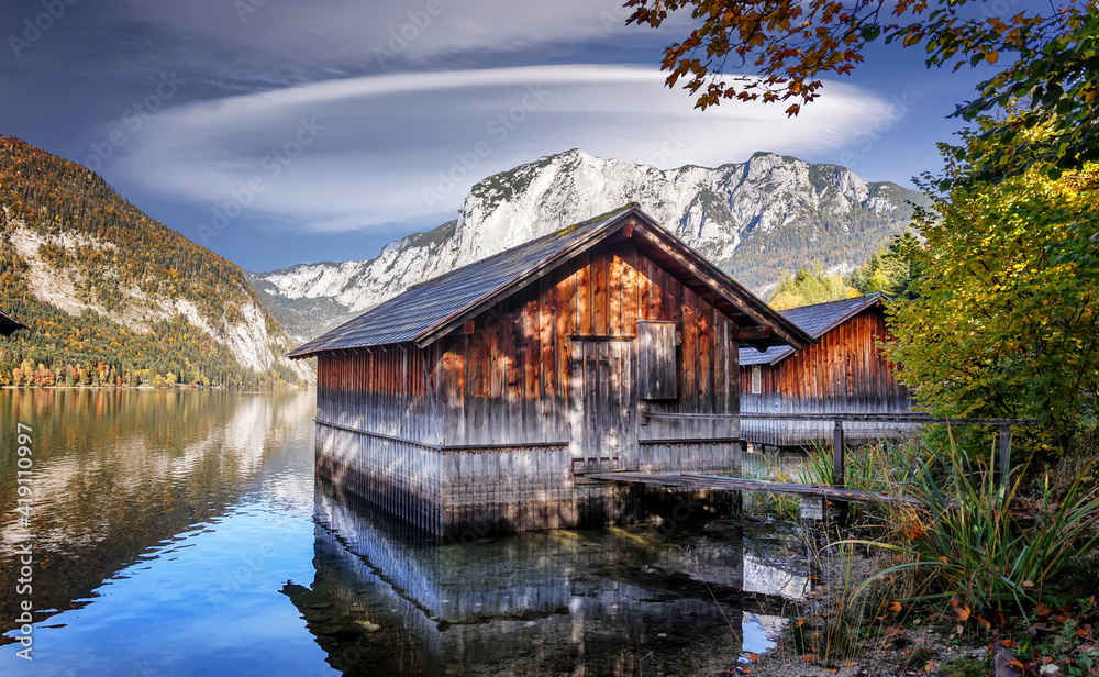 Wonderful sunny morning at Altausser lake. Awesome autumn scene. Amazing nature view. Wooden hut on Altausser lake in Altaussee village. Incredible lake in Austrian alps. concept ideal resting place Wonderful sunny morning at Altausser lake. Awesome autumn scene. Amazing nature view. Wooden hut on Altausser lake in Altaussee village. Incredible lake in Austrian alps. concept ideal resting place