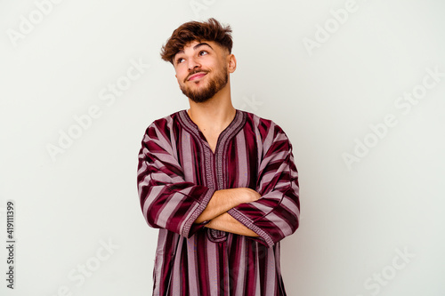 Young Moroccan man isolated on white background dreaming of achieving goals and purposes