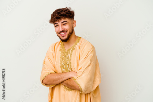 Young Moroccan man isolated on white background laughing and having fun. photo