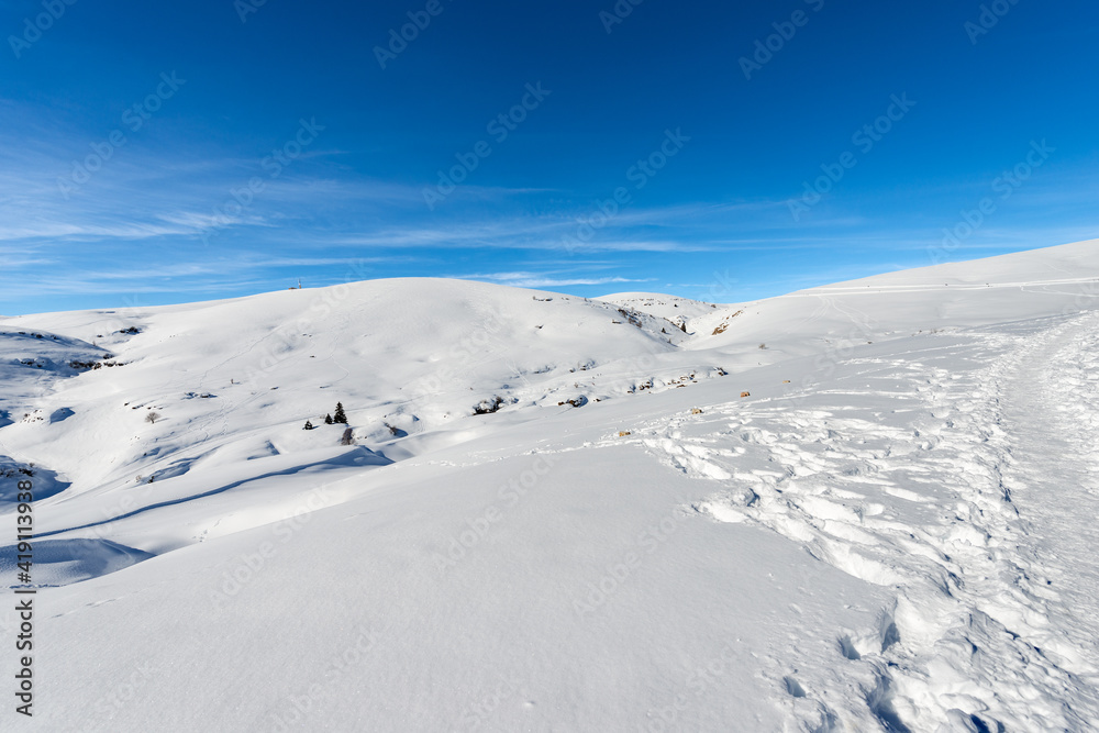 Lessinia high plateau (Altopiano della Lessinia) and peak of Monte Tomba (Tomb Mountain) in winter with snow. Malga San Giorgio, ski resort in Verona province, Veneto, Italy, Europe.