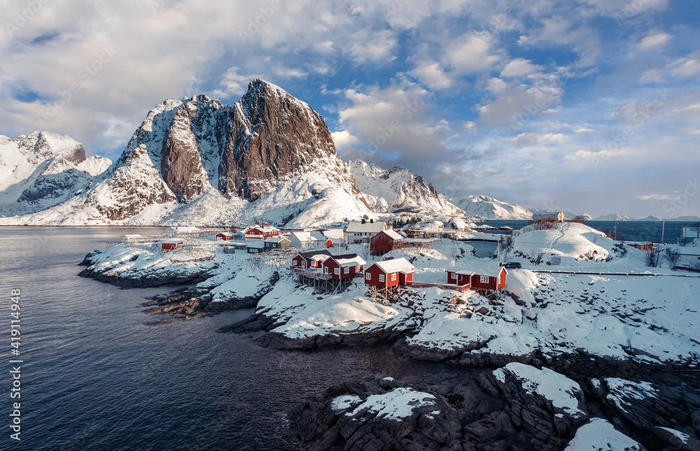 Hamnoy fishing village on Lofoten Islands, Norway with red rorbu houses in winter. Concept of Travel and holiday on nature, tourist and fishing leisure. Iconic location for landscape photographers.