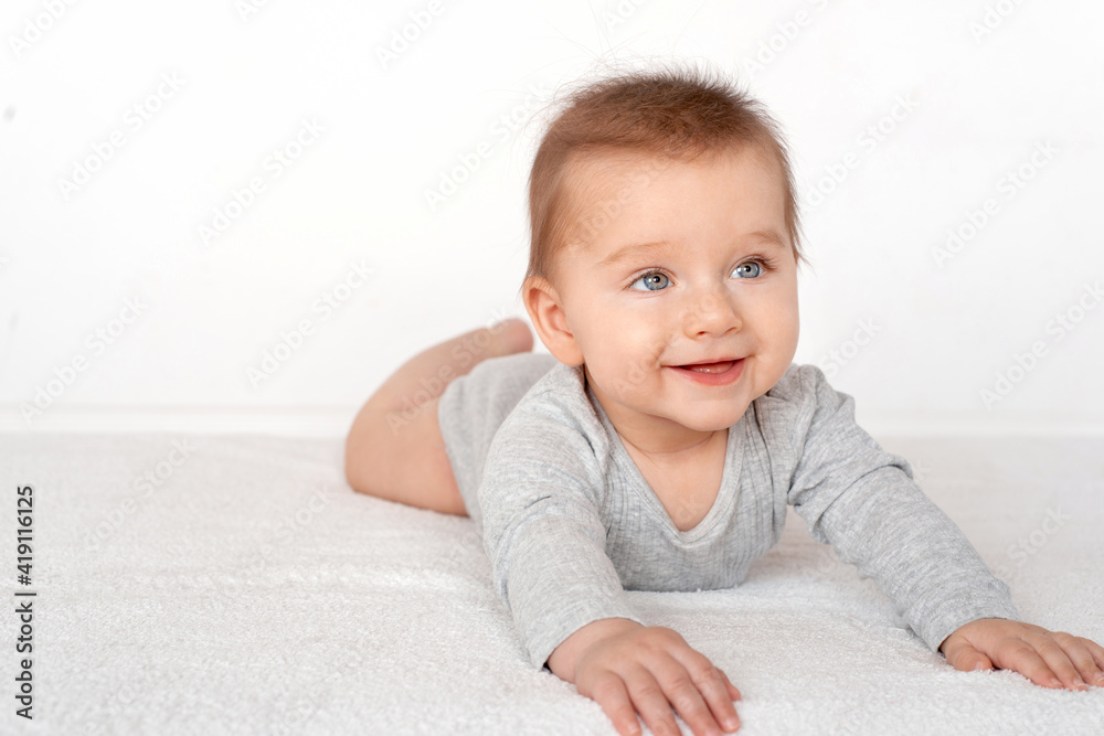 Portrait of a cute baby boy with blue eyes on white background