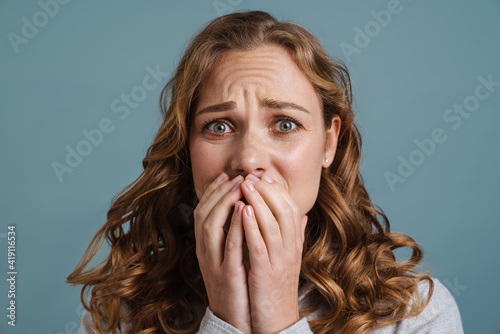 Young beautiful scared woman shocked covering mouth with hands for mistake