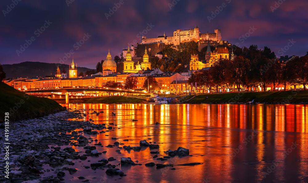 Fantastic colorful evening view on Salzburg historical city. Castle Hohensalzburg with night street light and perfect reflection. concept ideal resting place. Popular travel and historical center.