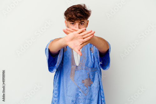 Young Moroccan man isolated on white background doing a denial gesture photo