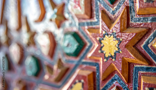 Close up of colored ornament on wood in traditional islamic style. © puhimec