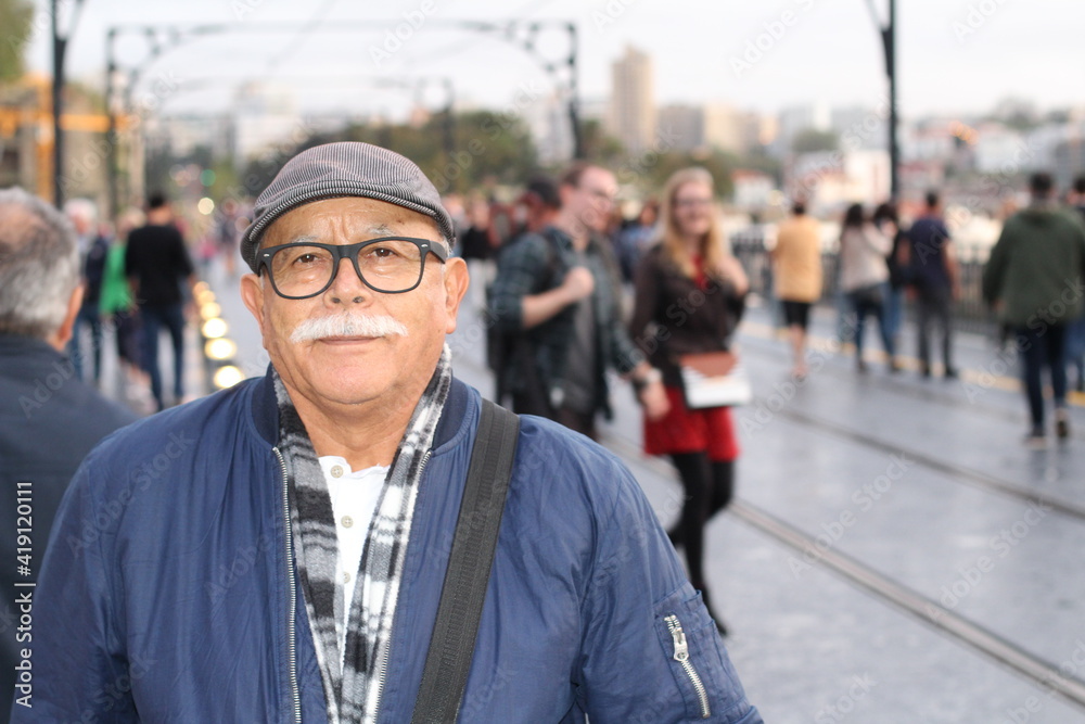Senior man with a mustache in crowded street Senior man with a mustache in crowded street