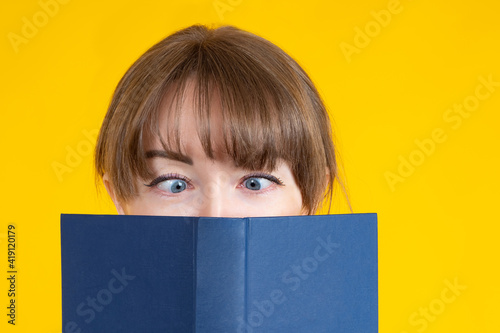 Girl reads a book close-up....