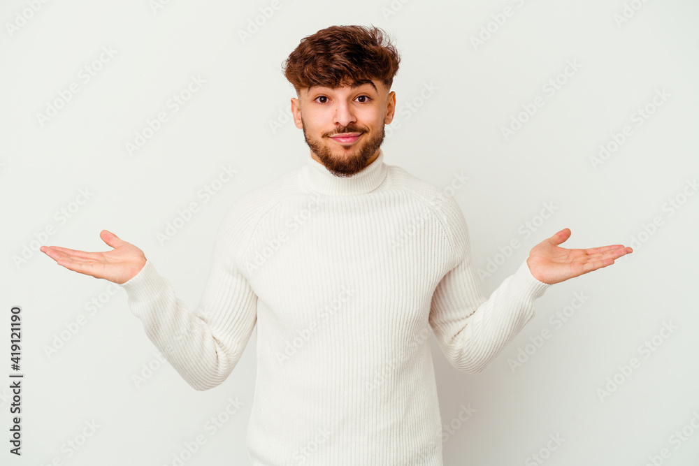 Young Moroccan man isolated on white background doubting and shrugging shoulders in questioning gesture. Young Moroccan man isolated on white background doubting and shrugging shoulders in questioning gesture.