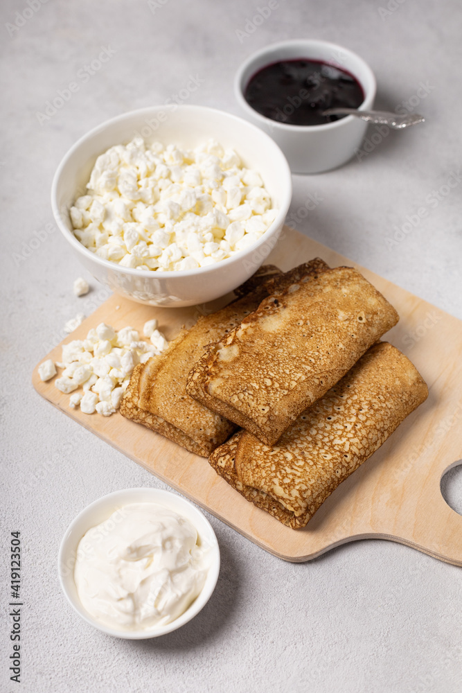 Pancakes roll on a light background close-up Pancakes roll on a light background close-up