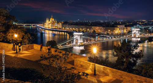 Photography Beautiful evening image of Budapest,  incredible view on Budapest cityscape, with streetlight and colorful sky during sunset