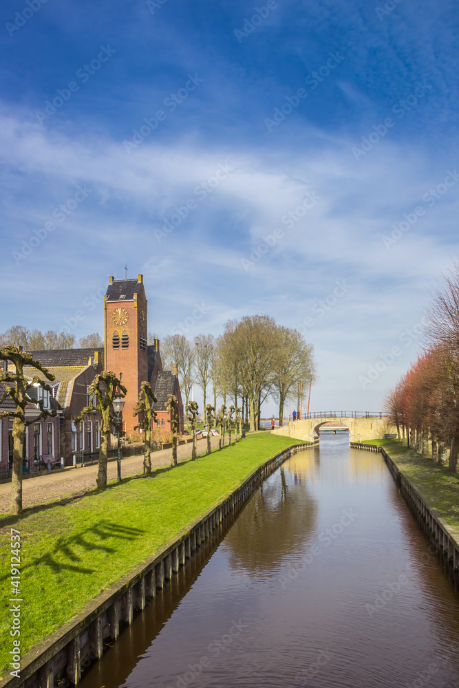 Fredericus church at the central canal of historic city Sloten, Netherlands