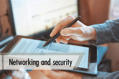The tablet in the hands of a businessman. Networking and security concept