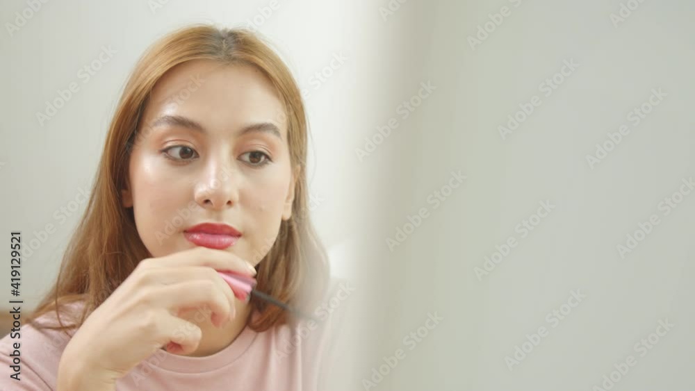 closeup of a young Asian woman doing makeup eyebrow brush and look at mirror. closeup of a young Asian woman doing makeup eyebrow brush and look at mirror.