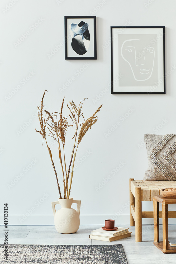 Interior design of scandinavian living room with stylish sofa, mock up poster frames, book, dried flower in vase, decoration and personal accessories in retro home decor. Template. Interior design of scandinavian living room with stylish sofa, mock up poster frames, book, dried flower in vase, decoration and personal accessories in retro home decor. Template.