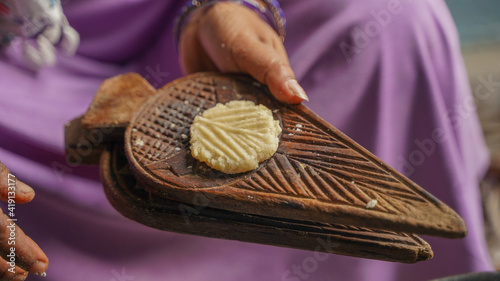 Woman making thekua for chhath puja photo